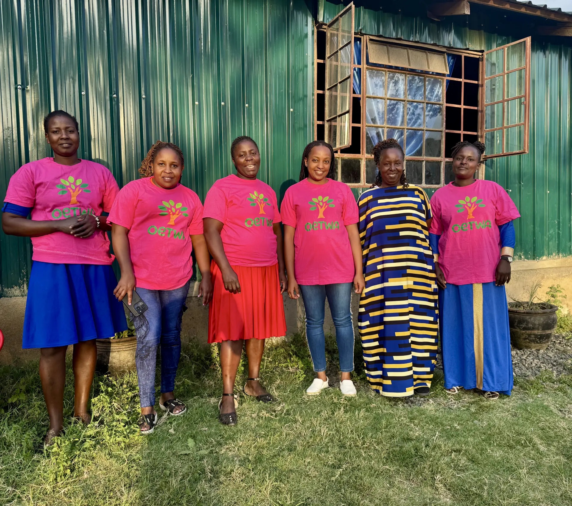 Six OETWA team members standing together outside the Nairobi community centre